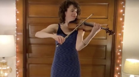 woman playing violin at quarantine concert