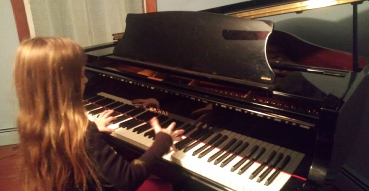 child playing on donated piano