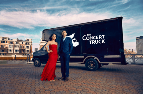couple standing in front of the concert truck