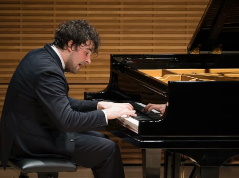 Martín Garcia García plays piano on stage at Carnegie Hall
